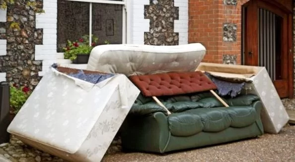 bulky waste sofa and mattress outside of house